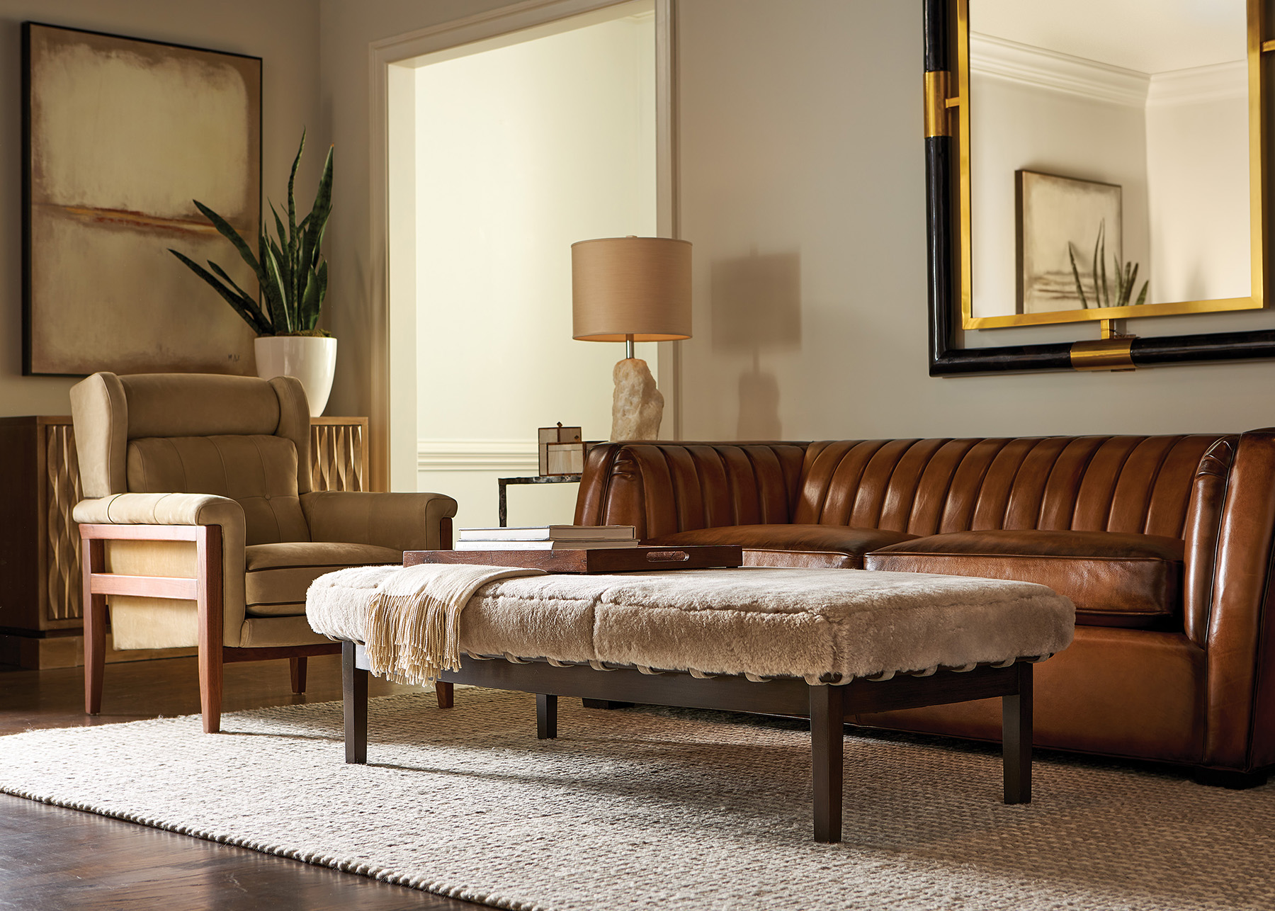 Aviator Sofa shown in Hyde Park Tan Patina Burnished with Java finish.  Heston Chair shown in Cottswald Burlap with Hand Rubbed Walnut finish.  Contrasting welts in Cottswald Dakota Brown.  Zelis Bench shown in Fleecy Fog with Lyric Shadow straps and Buck finish.